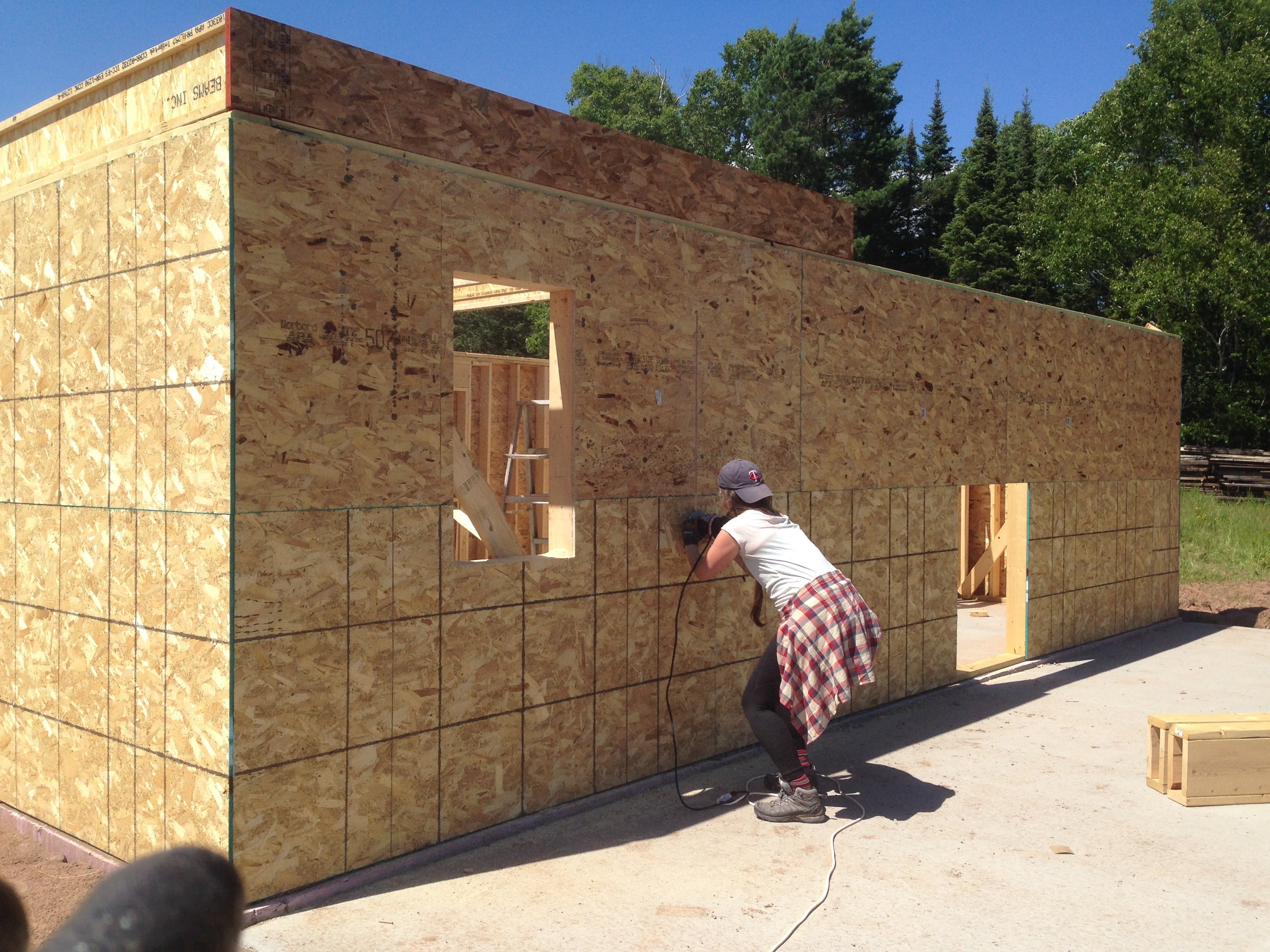 Bre cut out the window openings with a flush trim bit on the router.