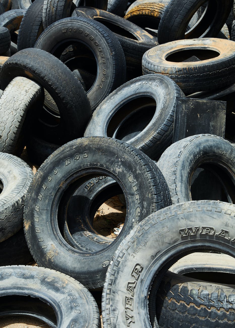 pile of many used tires in dust