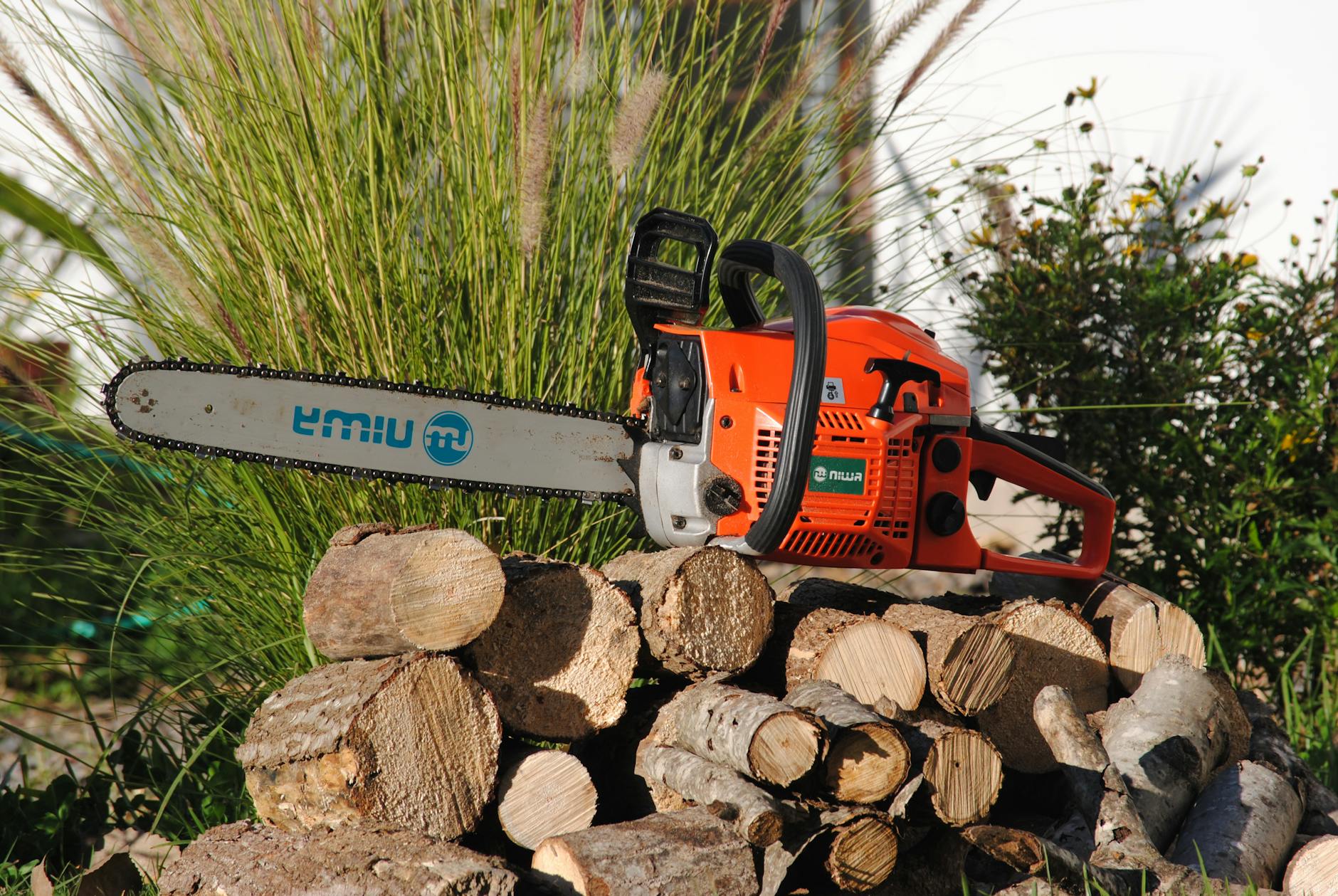 chainsaw on top of a pile of wood