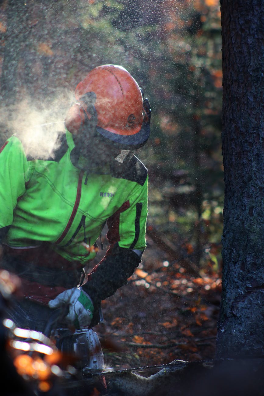 a man in green jacket wearing orange helmet